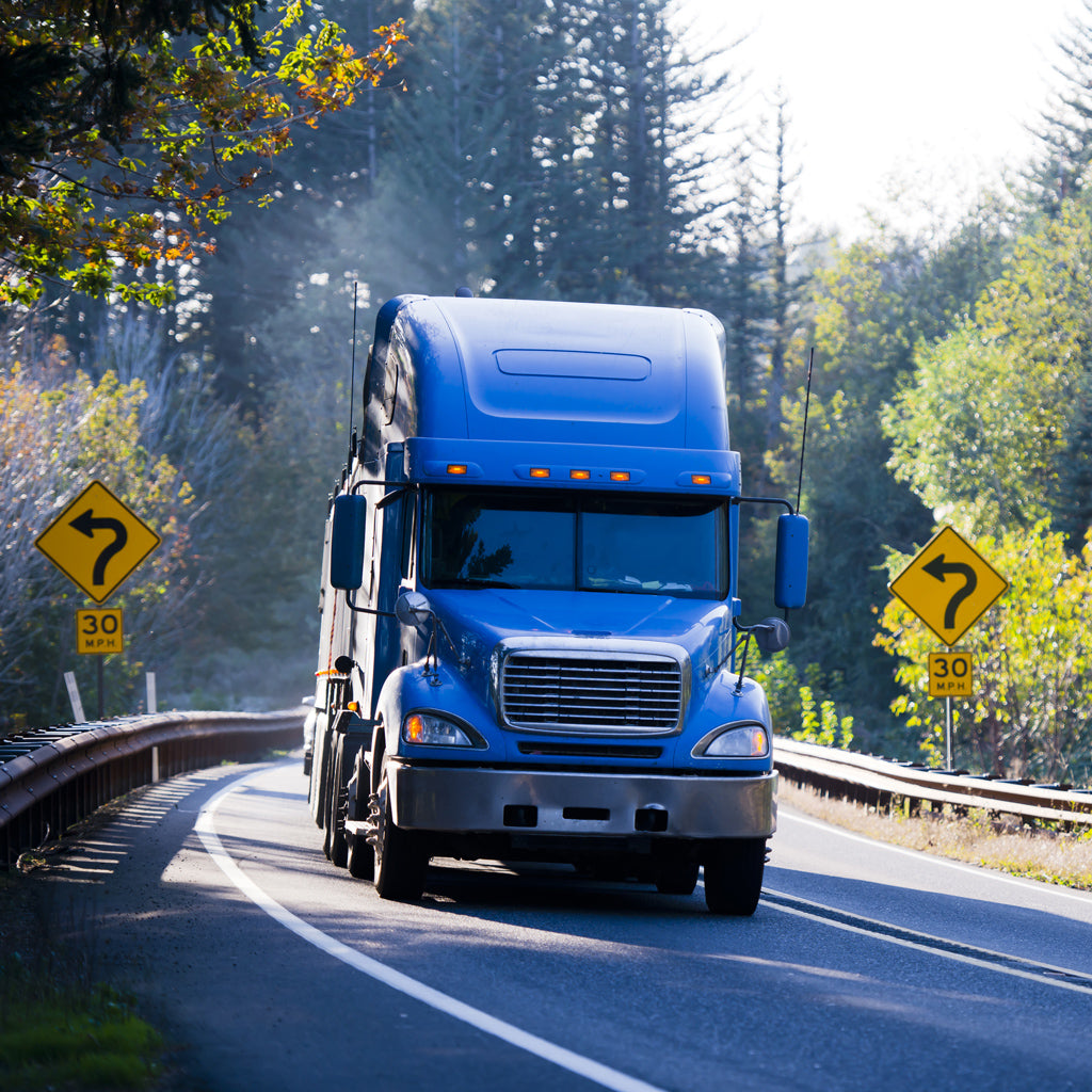 Semi traveling on a scenic road.